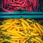 yellow and red chilis on plastic crate